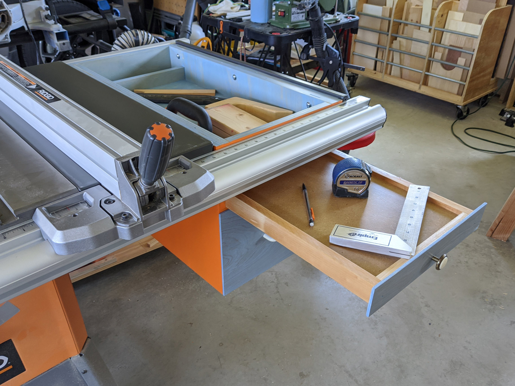 Table saw under-wing storage with pull-out shelf